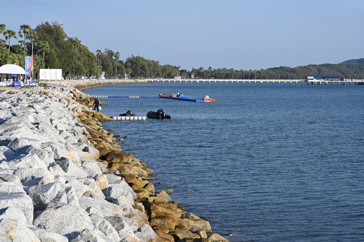 Rocky shoreline, calm water.