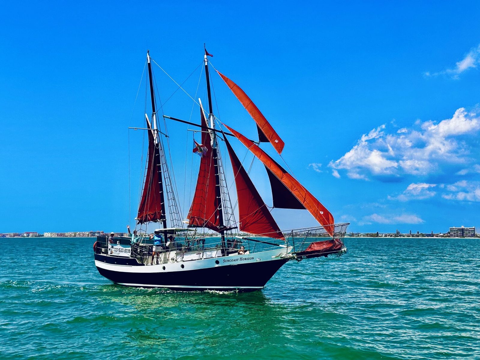 The schooner Suncoast Horizon under full red sails on the Gulf of Mexico off Treasure Island, Florida