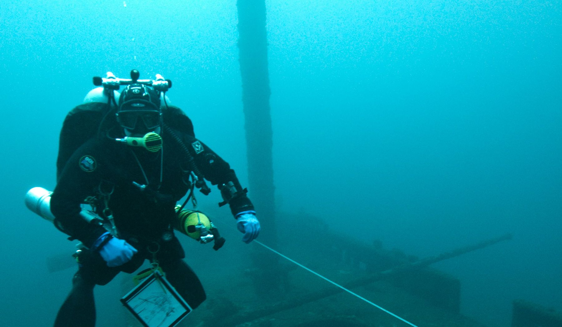 Technical diver with survey equipment underwater